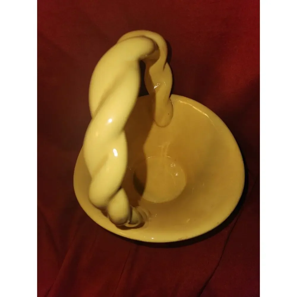 yellow ceramic basket has Leitsch on bottom